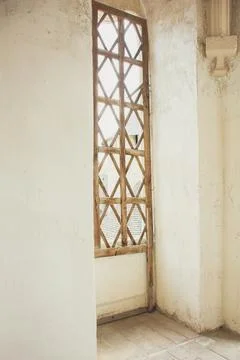 An old, antique window with a patterned lattice in an old building Stock Photos
