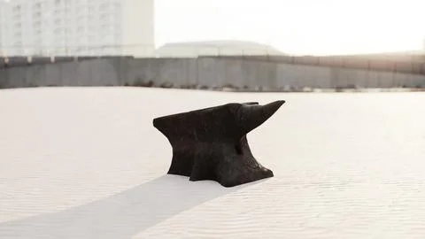 Old anvil on a sandy beach Stock Illustration