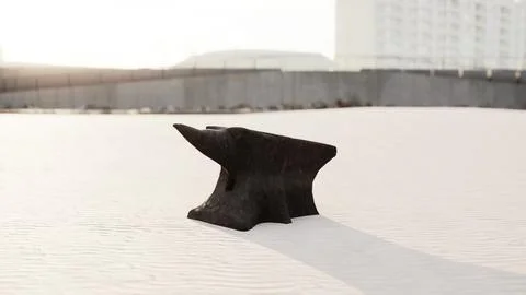 Old anvil on a sandy beach Stock Illustration