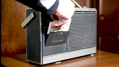 Old appliances, loading an audio cassette tape in a radio player Stock Footage 152684280