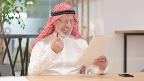 Old Arab Businessman Reading Documents and Celebrating Stock Footage 139775644