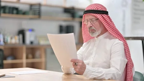Old Arab Businessman Reading Documents at Work 스톡 동영상 139776170