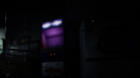 Old Arcade Machine Glows Softly in a Dark, Abandoned Game Room Stock Footage 344524632
