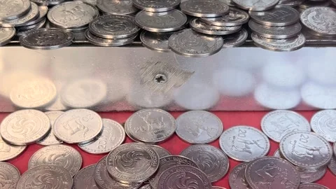 Old arcade push machine slot with Georgian metal coins 20 tetri Video stock 332932497