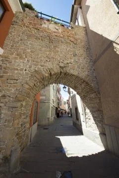 Old arch in muggia Stock Photos