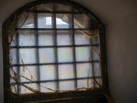 Old arched window with cracked translucent covering Stock Photos