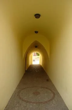 Old archway corridor with cobblestone floor Stock Photos