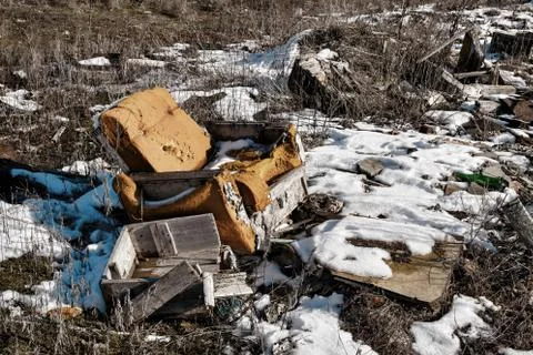 Old armchair on dump. Stock Photos