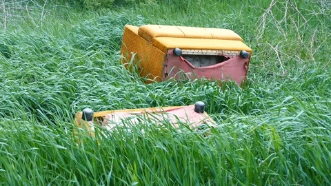 Old Armchairs Thrown Into The Grass Stock Footage 88606528