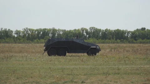 Old armored car from the second world war is moving through the meadow Stock Footage 121997139