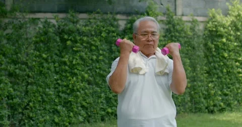 Old Asia man exercise and lift dumbbell, training for good health in park Stock Footage 140031691