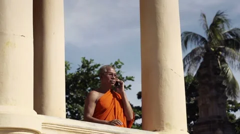 Old Asian buddhist monk talking with mobile phone in temple. With Model Release Stock Footage 10594270