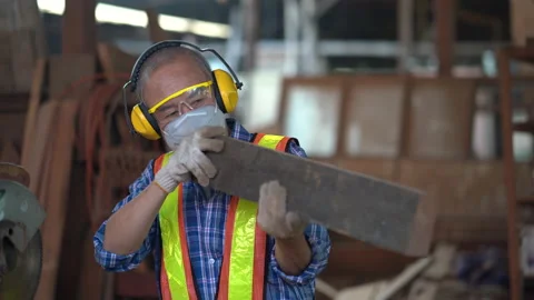 Old asian carpenter looking and checking wood in workshop . senior craftsman Stock Footage 149984156