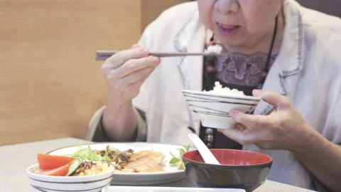 Old asian elderly senior elder woman eating japanese food at restaurant Stock Footage 149295300