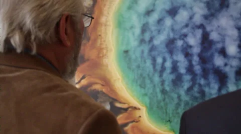 Old Asian man standing close to planet image Stock Footage 36152113