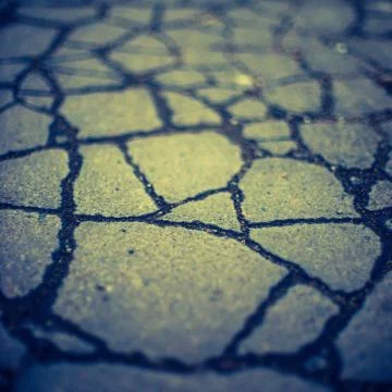 Old asphalt road surface in cracks. Stone texture 스톡 사진