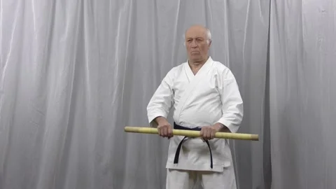 Old athlete teaches stick techniques in self-isolation conditions Stock Footage 130544324