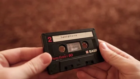 An old audio cassette in the hands of a close-up. Ferro Extra I 90. BASF 動画素材 164451274