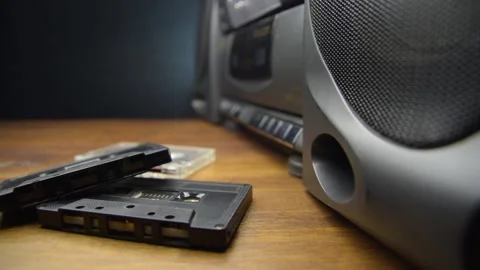 Old audio cassettes and a player on a wooden table Stock Footage 130969895
