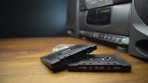 Old audio cassettes and a player on a wooden table Stock Footage 130969952