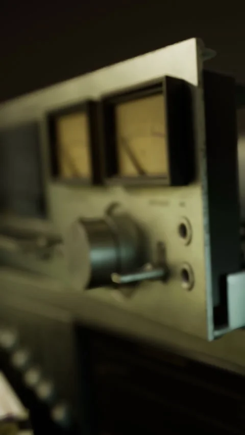 Old audio equipment shows dials and knobs in a studio setting at night Stock Footage 334258376