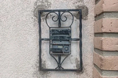 Old Audio intercom on the wall with metal protector. Stock Photos