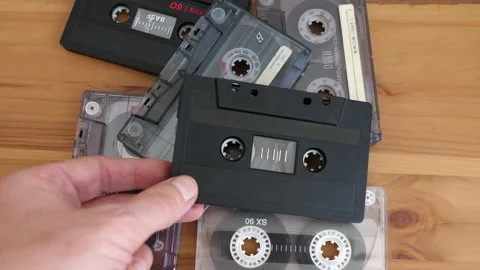 Old audio tapes at the table. Cassette tapes Stock Footage 141378972