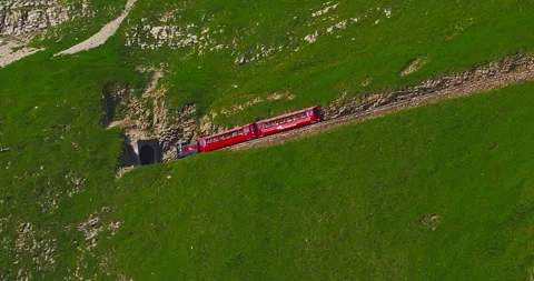 An old authentic red steam train travels of Switzerland and is a popular tourist Vídeos de archivo 302098177