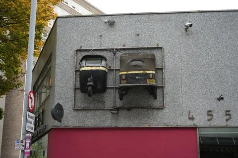 Old Auto-rickshaws Displayed On A Tiled Building Facade In Nottingham, England. Stock Photos