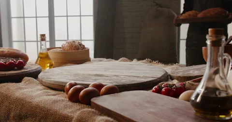 Old bakery chef bringing fresh loafs of wheat bread in a basket to the table Stock Footage 133122067