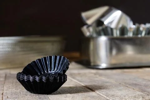 Old baking molds on an old kitchen table. Baking accessories in the kitchen. Stock Photos