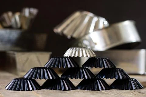 Old baking molds on an old kitchen table. Baking accessories in the kitchen. Stock Photos