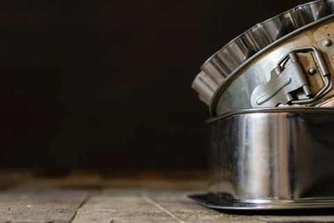 Old baking molds on an old kitchen table. Baking accessories in the kitchen. Stock Photos