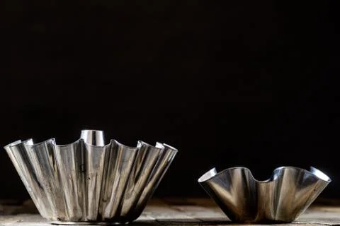 Old baking molds on an old kitchen table. Baking accessories in the kitchen. Stock Photos