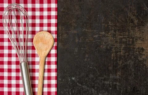 Old baking tray with red checkered table cloth and baking utensils Stock Photos