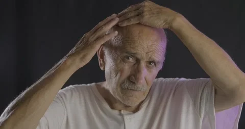 An old bald man is controlling his hair. Balding, lose hair concept. Stock Footage 136763003