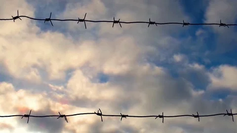 Old barbed wire against the sky, time lapse Stock Footage 82396754