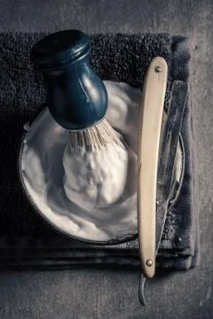 Old barber equipment. Sharp razor, soap and brush Stock Photos