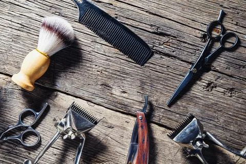 Old barber tools on rustic wooden weathered background Stock Photos