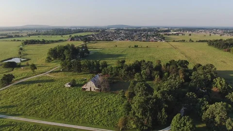 The old barn against the backdrop of the new suburbs Stock Footage 113148146
