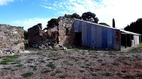 Old barn and fallen down structure Stock Photos