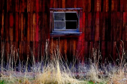 Old Barn in Field in Late Fall Autumn Brown Grass Weathered Red Wood Stock Photos