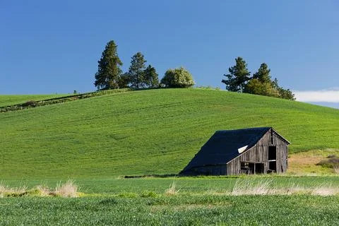 Old barn by hill. Stock Photos