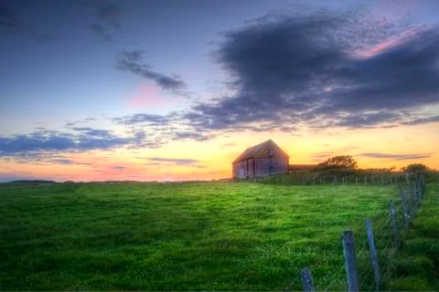 Old barn in landscape at sunset Stock Photos