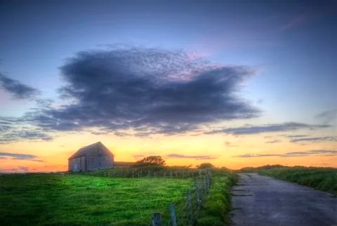 Old barn in landscape at sunset Stock Photos
