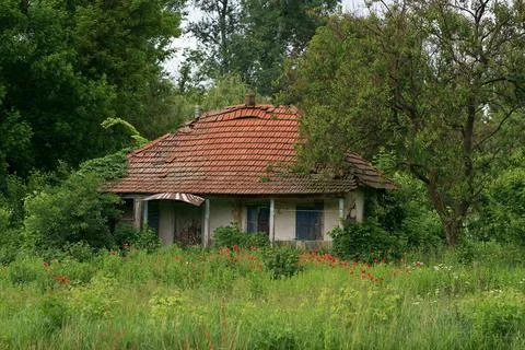 An old barn standing alone in the field of a farm. Rustic, weather-worn barns Stock Photos