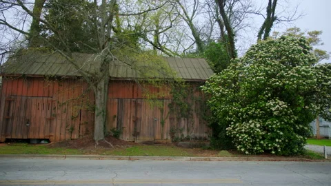 Old barn stands on the quiet town street Stock Footage 315174508