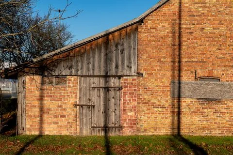 Old barn structure showcasing rustic charm in bright sunlight Stock Photos