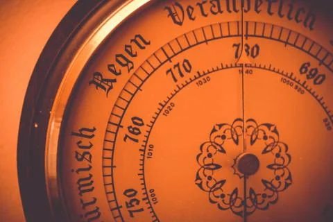 Old barometer dial close up with added orange filter Stock Photos