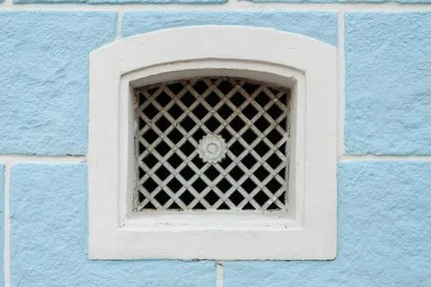 Old Basement Window on a Blue Wall in a colonial Brazilian House Stock Photos